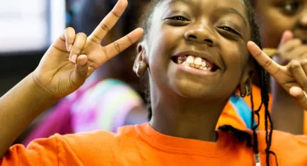 Girl smiling with peace sign