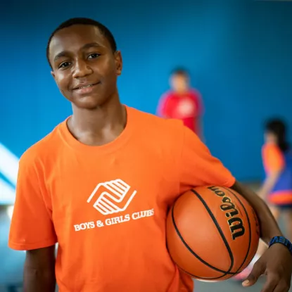 Kid holding a basket ball