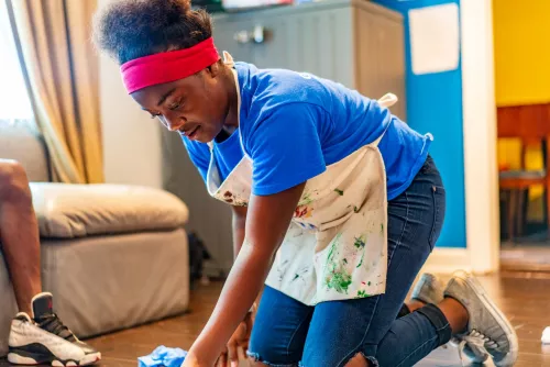 Youth kneeling with painted apron 