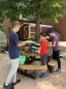 Youth repotting flowers for green house. 